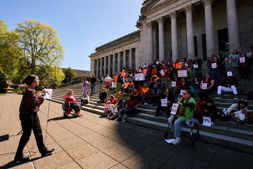 Michele Thomas, director of policy and advocacy for the statewide Low Income Housing Alliance in Washington, speaks during a rally advocating for lawmakers to adjust and pass House Bill 1217, a rent-control bill, at the Washington State Capitol Building Friday, April 18, 2025, in Olympia, Wash.
