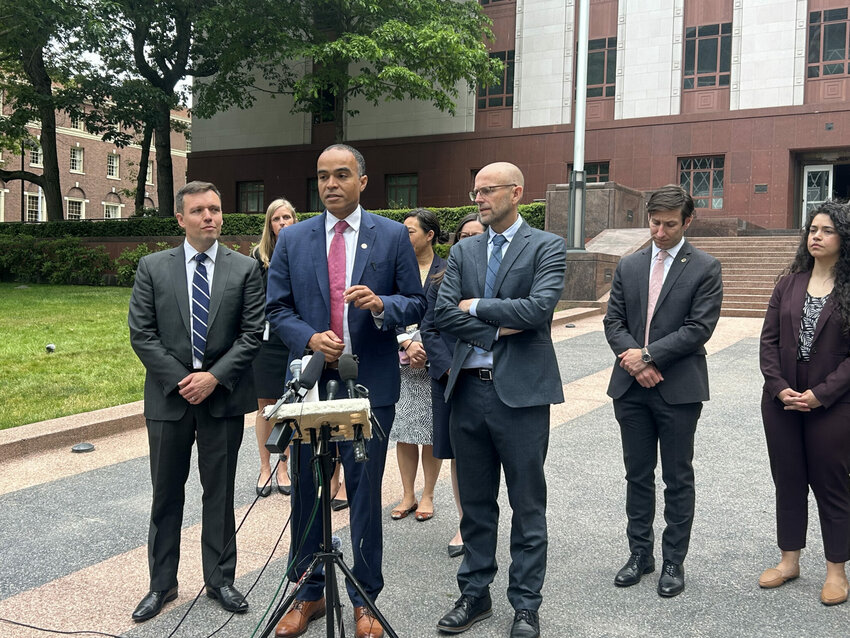 Washington Attorney General Nick Brown, center, speaks to reporters alongside Solicitor General Noah Purcell, left, and Northwest Immigrant Rights Project Legal Director Matt Adams, right, outside a Seattle courthouse where federal appeals court judges heard arguments over President Donald Trump&rsquo;s executive order on birthright citizenship on Wednesday, June 4, 2025. (Photo by Jake Goldstein-Street/Washington State Standard)