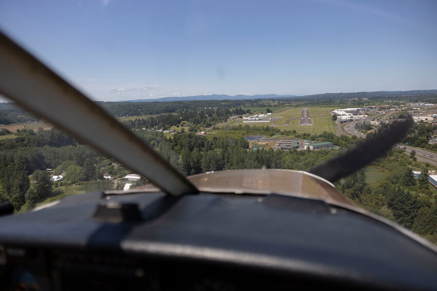 Reid Balmelli, owner of Chehalis Skies Aviation LLC, flies his plane to land at the Chehalis-Centralia Airport on Thursday, June 5.