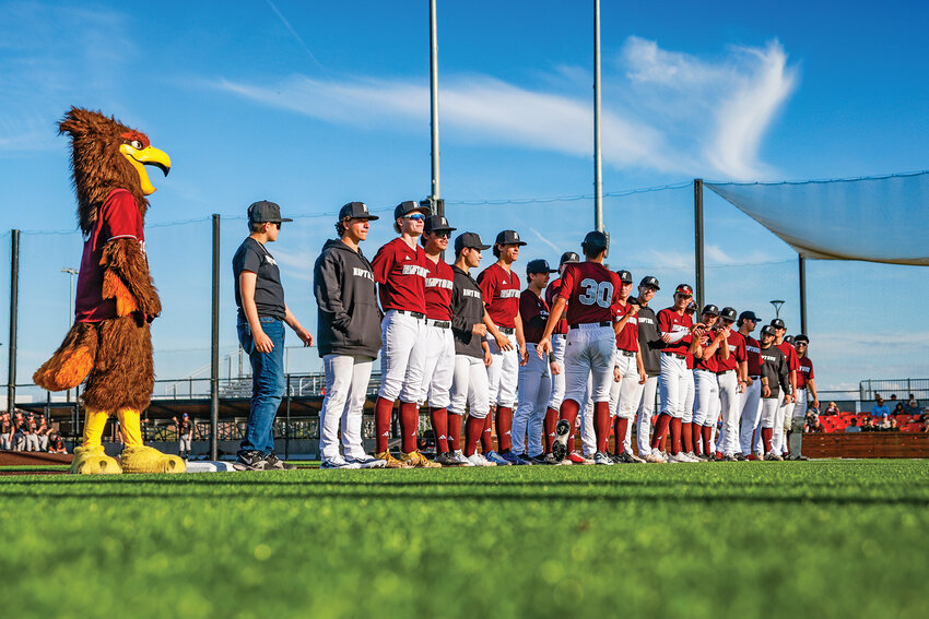 Ridgefield Raptor players line the third base line as the players are introduced for the season on opening day against the Cowlitz Black Bears at the Ridgefield Outdoor Recreation Complex on Thursday, May 29.
