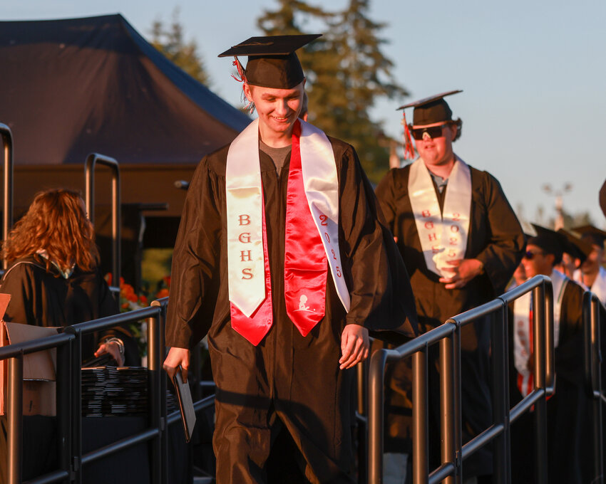 Kaden Spencer, a Battle Ground teen, walks off the Battle Ground High School graduation stage on Friday, June 6, with a diploma in hand as the wind reveals his St. Jude&rsquo;s Children&rsquo;s Hospital stole. Spencer missed his senior year of in-person instruction after he was diagnosed with an aggressive form of brain cancer.