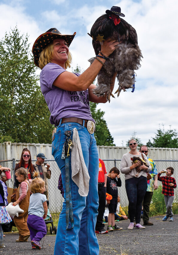 Shelly Green of Yacolt shows off Batman the chicken, decked out in a sheriff&rsquo;s outfit complete with a hat and badge. Batman won &ldquo;Best Dressed&rdquo; at Yacolt&rsquo;s first Chicken Fashion Show on June 14.