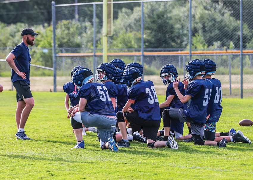Hockinson High School&rsquo;s new football coach Ben Nelson addresses the younger players after a practice during the spring season on Wednesday, June 11.