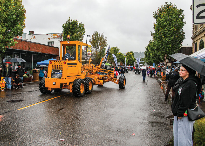 Heavy machinery from Blue Line Land Works LLC rolls down Davidson Avenue during the Planters Day parade on Saturday, June 21, in downtown Woodland.