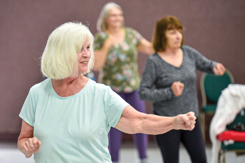 Rose Kreps throws a series of air punches during an EnhanceFitness class on June 18 at Bethel Lutheran Church in Brush Prairie. The routine supports cardiovascular health for older adults through low-impact aerobics.