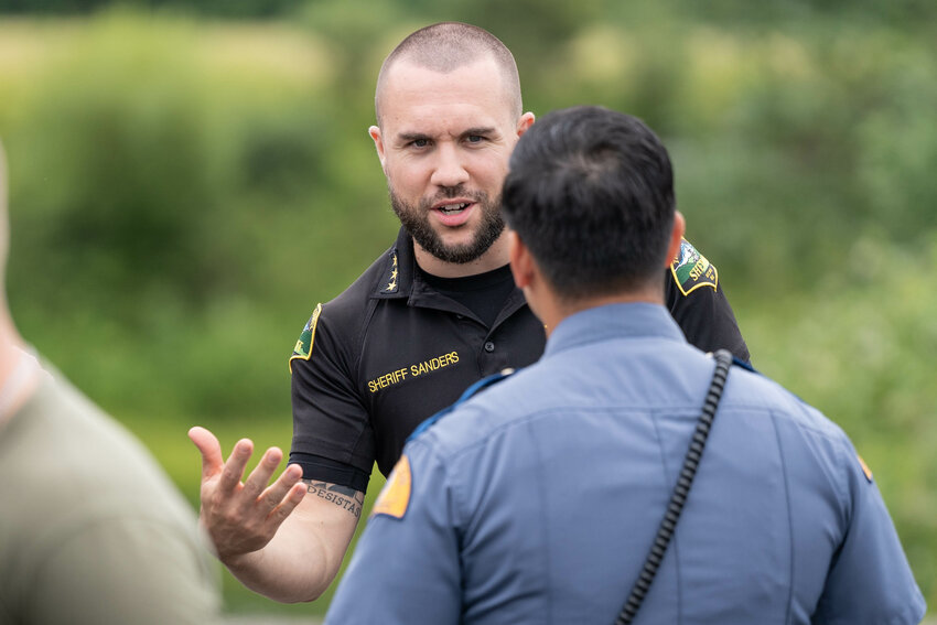 Thurston County Sheriff Derek Sanders speaks with a Washington State Patrol trooper in this file photo.