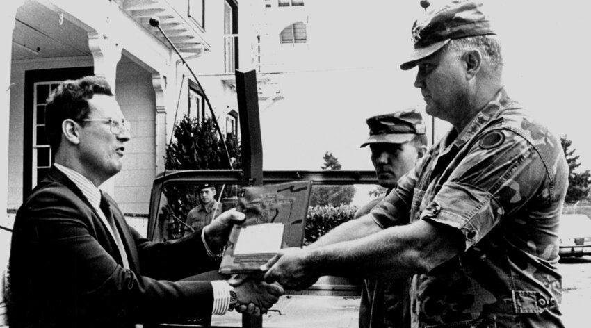 Norman Schwarzkopf, then a lieutenant general, transfers his command jeep to Alan Archambault, director of the Lewis Army Museum, in 1987.