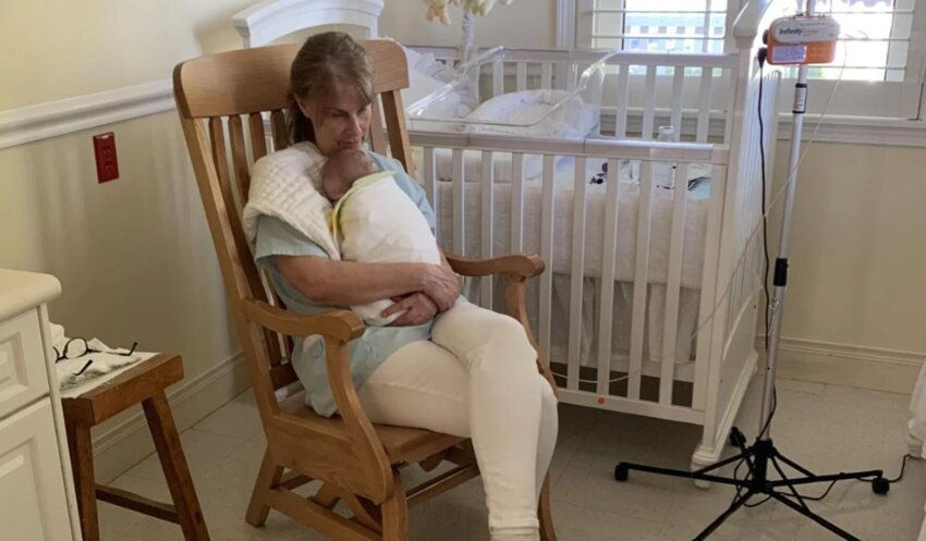 PICC staff member Ronda rocks last baby June 30, 2025. WA DCYF cancels contract with PICC, after 35 years caring for drug addicted newborns.