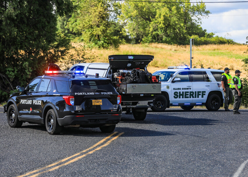 A Portland Police Bureau vehicle, bomb squad truck and a Clark County Sheriff&rsquo;s Office vehicle block off Northeast 179th Street just east of the fairgrounds exit on Interstate 5 after a Portland Police Bomb Squad member set off a small explosive in the intersection of Northeast 179th Street with the northbound off-ramp and Northeast 10th Avenue in Ridgefield on Thursday, July 10.