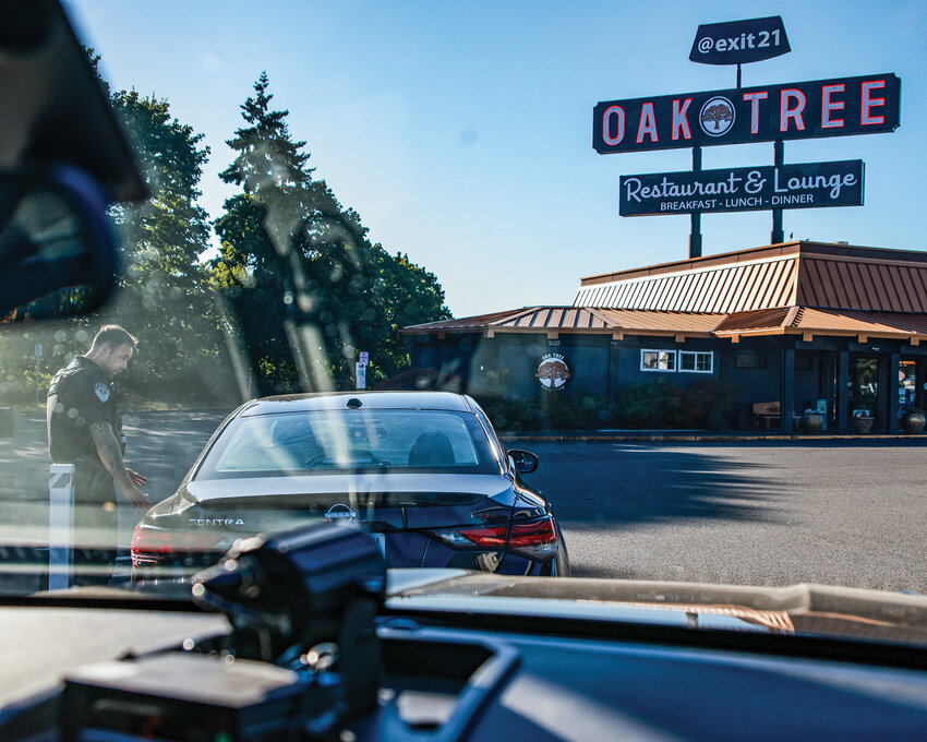 Woodland Police Officer Roberto Cuneta talks to a driver during a traffic stop after observing the vehicle commit multiple traffic violations on Tuesday, July 15.