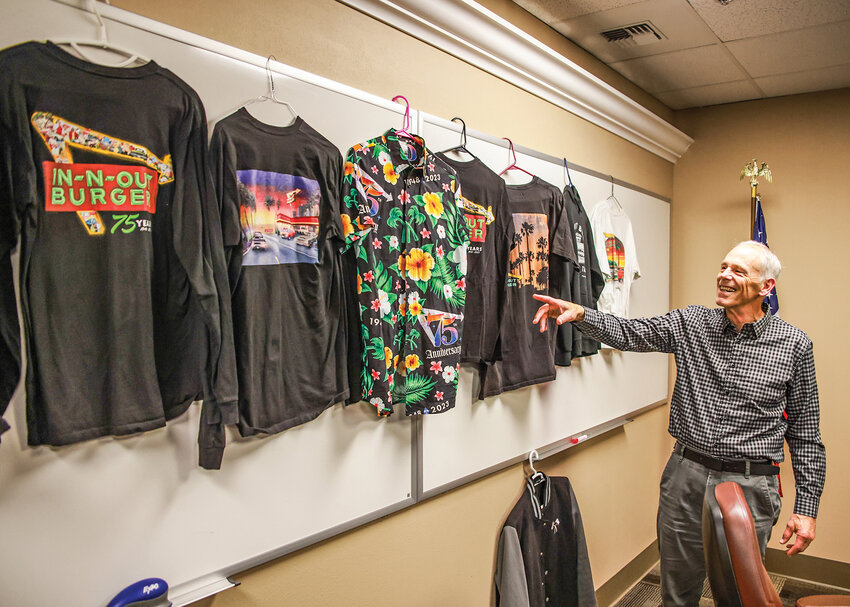 Steve Mathis, of Ridgefield, points out an In-N-Out Burger shirt on Tuesday, July 15, that he plans on wearing for the opening day of the first location in the state of Washington at Ridgefield&rsquo;s Union Ridge Town Center.