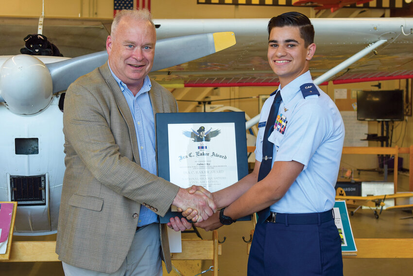 Cadet Lieutenant Colonel Andrew Roy, right, accepts the Ira C. Eaker Award, presented to him by Rep. Jim Walsh. The promotion ceremony took place on Monday, July 14, at Pearson Field and recognized Roy&rsquo;s leadership accomplishments in the Civil Air Patrol.