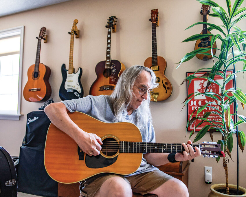 Battle Ground musician Dan Dingman plays his 1972 Martin D-28 in his home on Thursday, July 17.