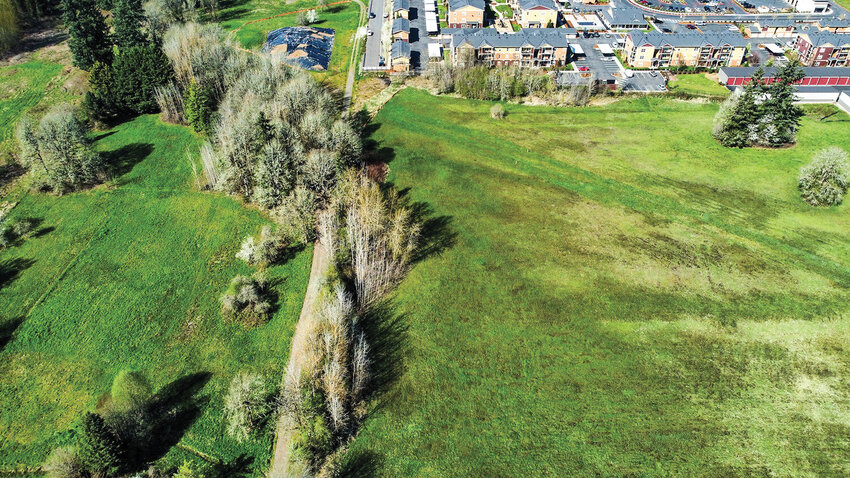 A parcel of land sits undeveloped near the Alder Pointe Apartments and Walmart in Battle Ground. The site is the proposed location of Eaton Park, a 95-unit development that could move forward if the city updates its residential zoning code. Twenty percent of housing units would be set aside as "affordable housing" for those making less than 80% of the area's adjusted median income.