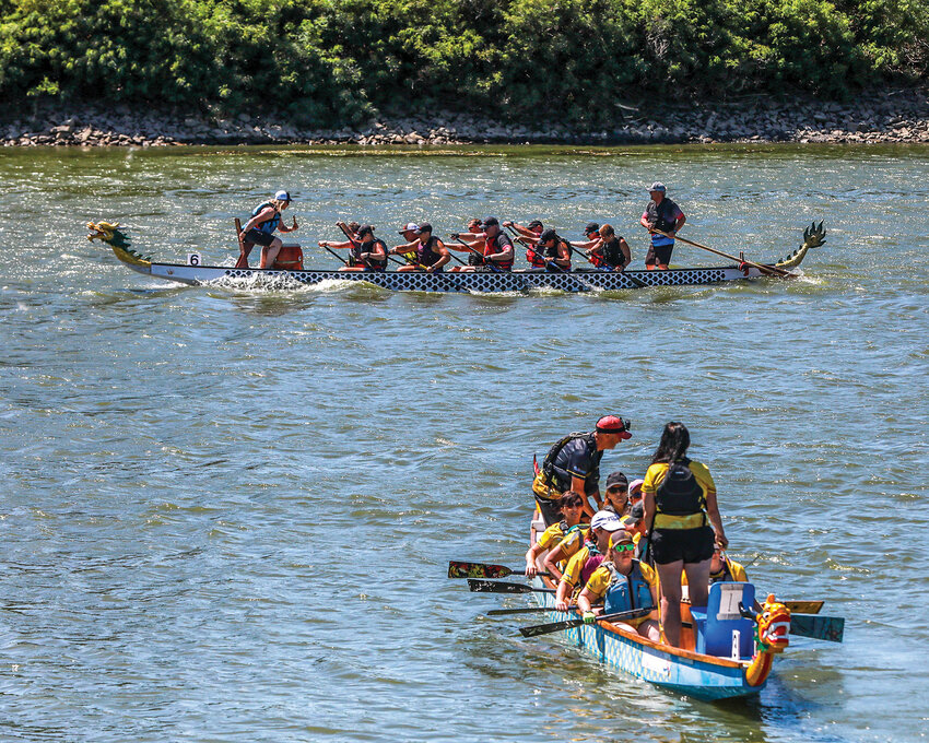 Paddlers power through the windy conditions and head upstream for the annual Paddle For Life dragon boat races that occurred at the Ridgefield waterfront on the Lake River on Saturday, Aug. 2.