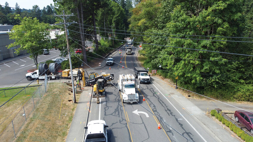 Cars travel through a one-lane closure as crews implement new lighting on Fourth Street. The road will undergo full street reconstruction that adds sidewalks, bike lanes and a new bridge over Breeze Creek to the area between East Stonecreek Drive and Highland Avenue.
