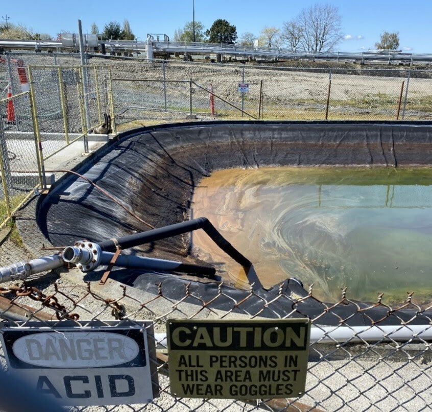 A portion of a 150,000-gallon pond at the Marathon Anacortes refinery, where Washington state officials say Tesoro mishandled acid waste. (Photo courtesy of Washington State Department of Ecology)