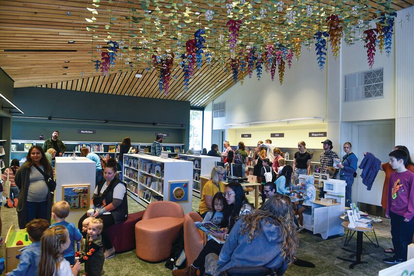 Families explore the new Woodland Community Library during its first opening last year. The Fort Vancouver Regional Library levy lid lift is currently leading in district-wide results and, if approved, would help fund expanded hours, staffing and materials across the system.