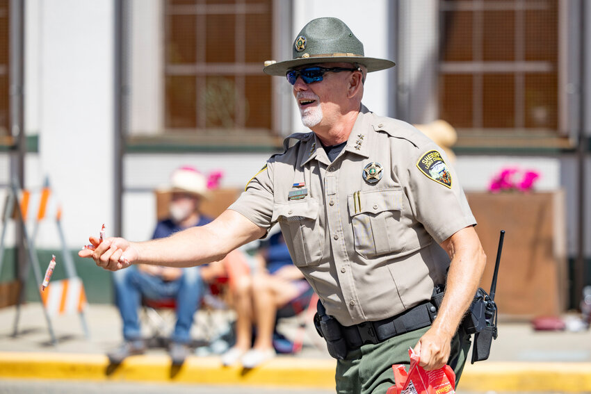 Sherriff Rob Snaza throws candy during the Loggers Jubilee Parade in Morton on Saturday, Aug. 9.