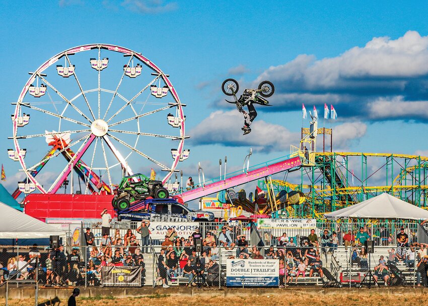 A big-air motocross freestyle rider performs a backflip ahead of the 7 p.m. side-by-side racing show at the Clark County Fair Grandstands on Thursday, Aug. 7.