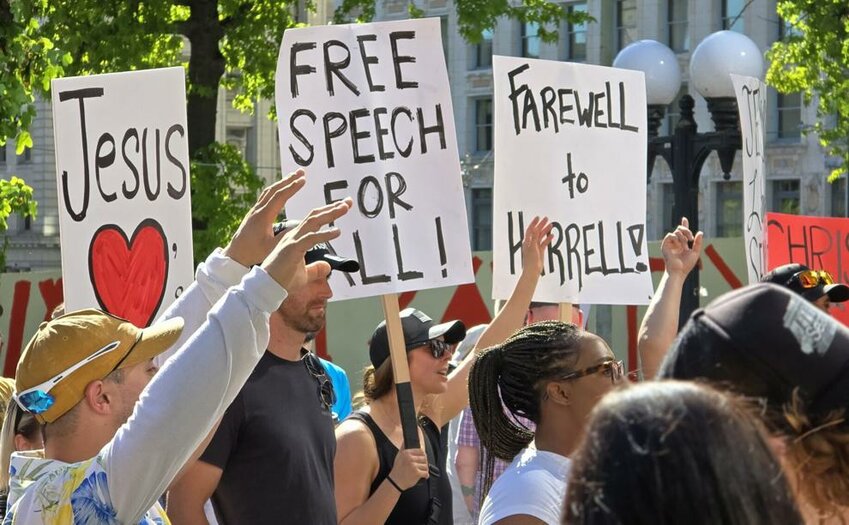 Protesters stand outside Seattle City Hall calling for Mayor Bruce Harrell to resign after his comments on a rally earlier this year.