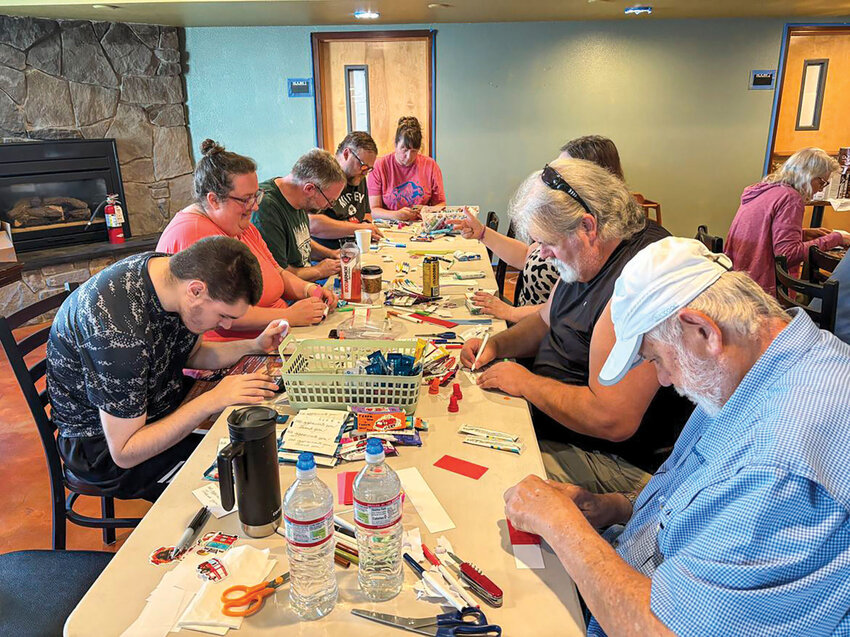 Volunteers at Saving Grace Church of the Nazarene in Battle Ground assemble healthy snacks, hydration packets and handwritten notes on July 12 for delivery to local police and fire departments. The effort is one of several recent projects by the church, which is hosting a free haircut event Aug. 24 as part of its renewed mission to serve the community.