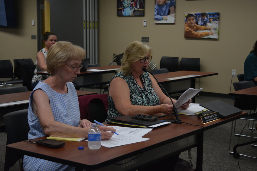 Michelle Scott, Battle Ground Public Schools chief financial officer (right), gives an update to the school board during an Aug. 11 work session. The board received a detailed presentation on the expected impacts of the 2025-26 budget following the failure of the district&rsquo;s replacement levy.