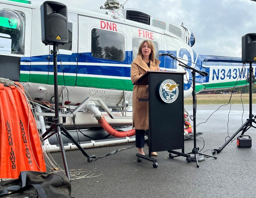 Former Commissioner of Public Lands Hilary Franz speaks to reporters at the Department of Natural Resources hanger at the Olympia Regional Airport in October 2023. (Laurel Demkovich/Washington State Standard)