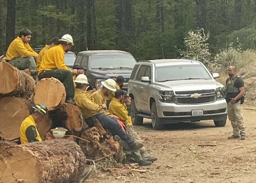 Federal law enforcement agents, including with the U.S. Border Patrol, arrived at a site Wednesday afternoon to demand identification from private contracting crews fighting the Bear Gulch Fire near Lake Cushman. (Courtesy of fire crew via The Seattle Times)