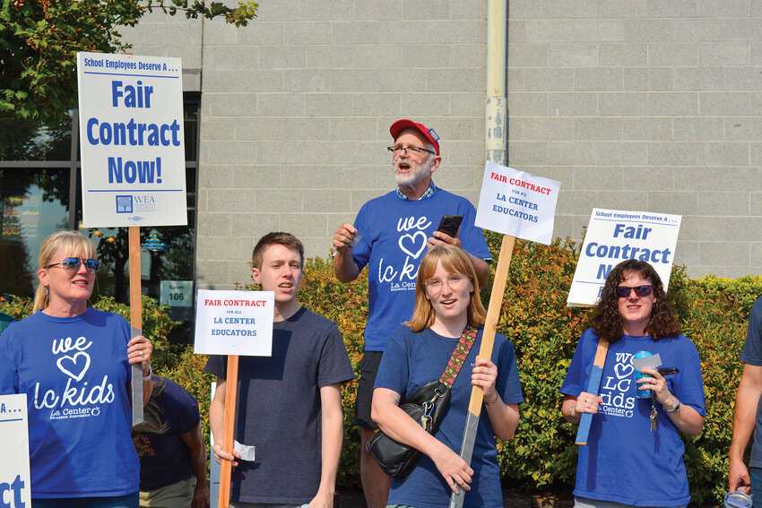 Former La Center Education Association president and current middle school teacher Warren Westerberg leads a chant outside La Center High School on Monday, August 25. The rally took place ahead of another round of bargaining with the district over cost-of-living adjustments to teacher salaries.