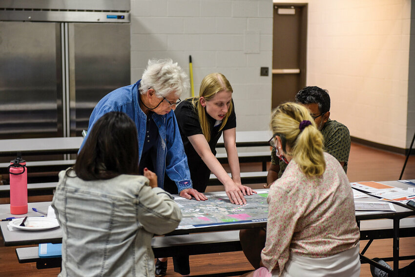 Participants of the Sept. 10, 2024, Envision Ridgefield 2045 open house discuss areas for future development that should be prioritized or limited with Community Development Director Claire Lust (center).