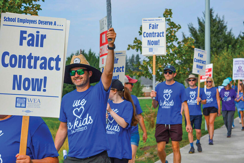 La Center Education Association members walk the picket line in front of La Center Middle School on Wednesday, Sept. 3. Teachers began striking after contract negotiations with the district stalled over salary adjustments.