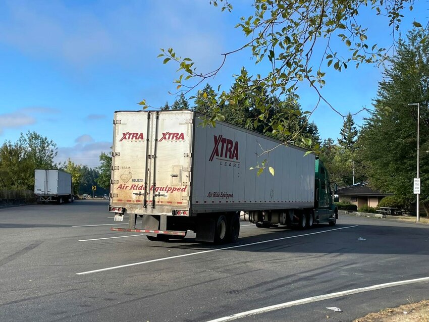 Truck parking can be hard to find in rest areas on Interstate 5 in Washington. A new effort will enable drivers to learn if they are available spaces before they get to a location. (Photo by Jerry Cornfield/Washington State Standard)
