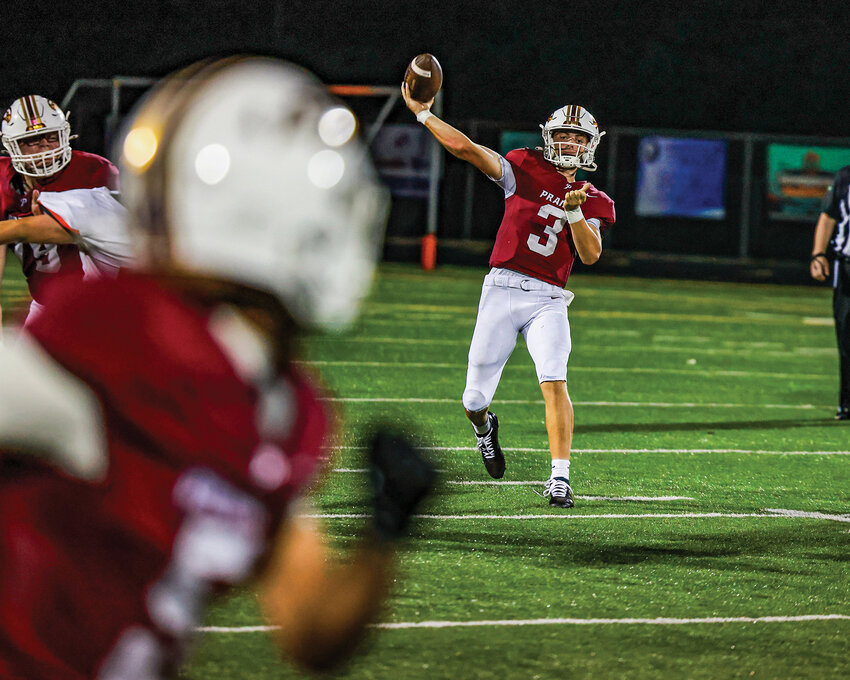 Prairie quarterback Deven Vigue looks downfield as he unleashes a long pass during the Falcons&rsquo; 48-22 win over the Washougal Panthers on Friday, Sept. 12.