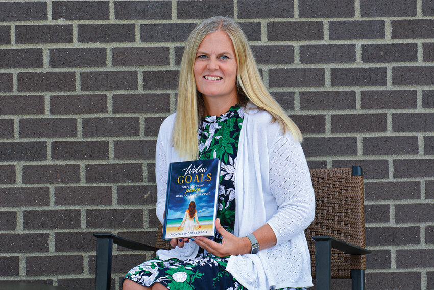 Michelle Bader Ebersole holds a copy of her book &ldquo;Widow Goals: Steps to Finding Peace When You Lose Your Spouse.&rdquo; Ebersole, a certified Grief Recovery Method specialist, will lead a new monthly grief support group hosted at the Battle Ground Senior Center starting in October.