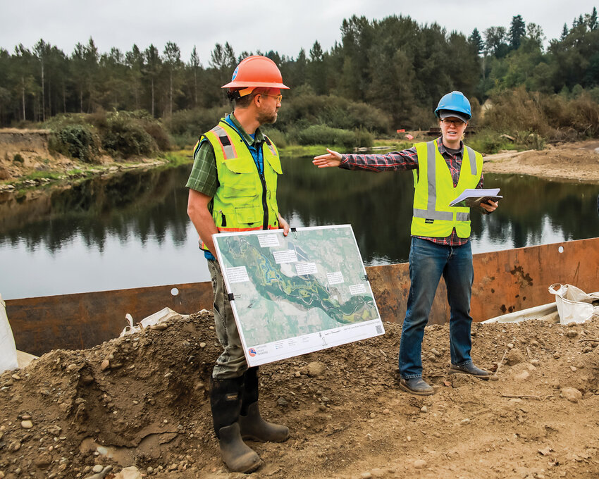 Chris Collins, left, and Jasmine Zimmer-Stucky, of the Lower Columbia Estuary Partnership, explain the East Fork Lewis River Reconnection Project during a tour of the project on Thursday, Sept. 11.
