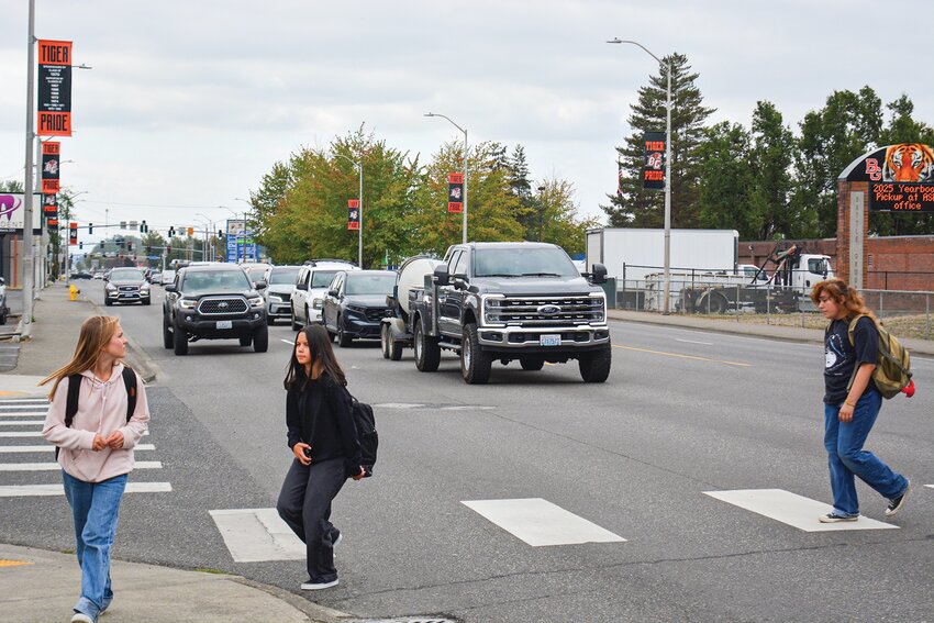 Students cross the intersection of Main Street and Third Avenue without the help of crossing guards. The number of guards across Battle Ground schools dropped from 25 to seven after voters rejected a levy earlier this year.