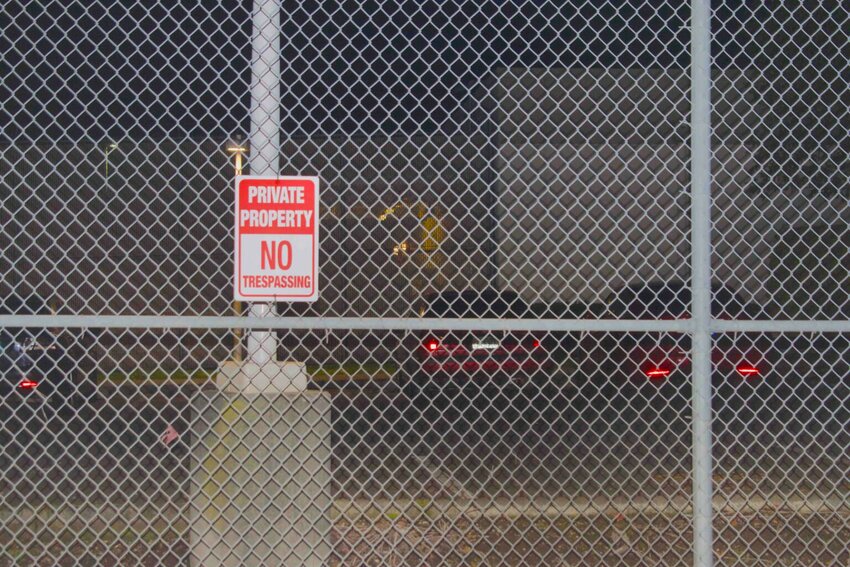 A 'no trespassing' sign on a fence outside the Northwest ICE Processing Center. (Photo by Grace Deng/Washington State Standard)