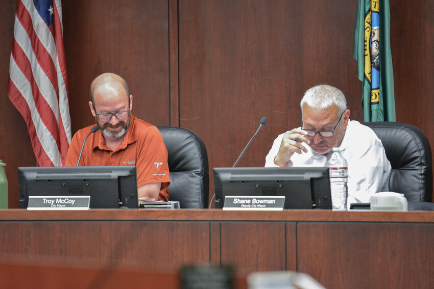 Battle Ground Mayor Troy McCoy, left, and Councilmember Shane Bowman listen during the Sept. 15 city council meeting. The council debated whether to support legal action over the C-Tran board&rsquo;s 3-3-3 composition.