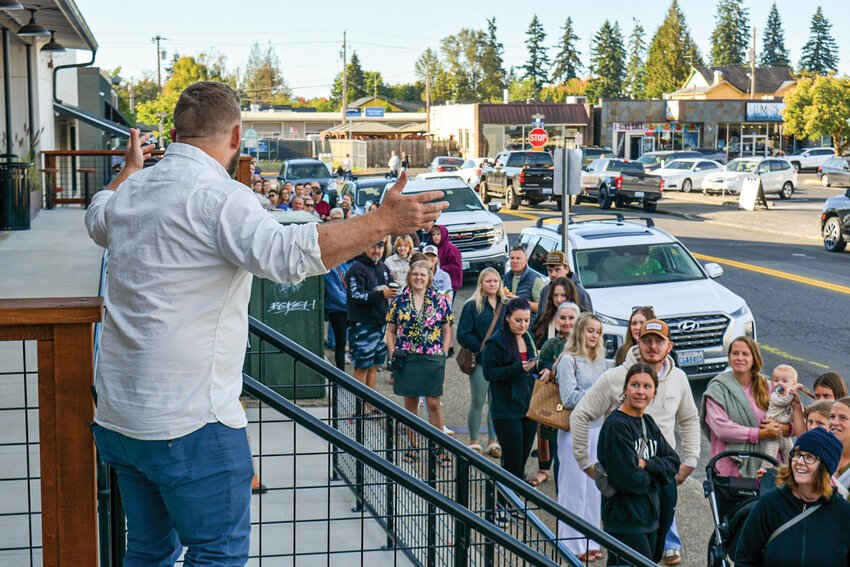 James Townley welcomes a long line of customers to the Battle Ground Farmers Market during its opening day on Saturday, Sept. 27. The market will operate weekly through Nov. 8 before closing for the winter.