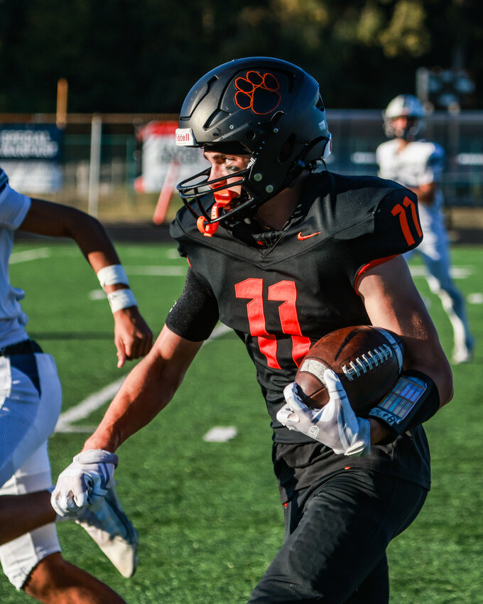 Battle Ground wide receiver Broderick Heerlein heads up field with a catch and run for a big gain in the Tigers&rsquo; 26-23 overtime loss to Cascade Christian High School (Puyallup) on Saturday, Sept. 27.