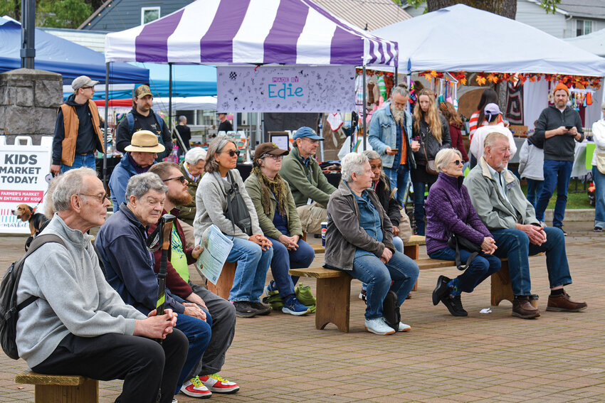 Locals stop and listen to bluegrass music played at Overlook Park during the 26th Birdfest and Bluegrass Festival on Oct. 4.