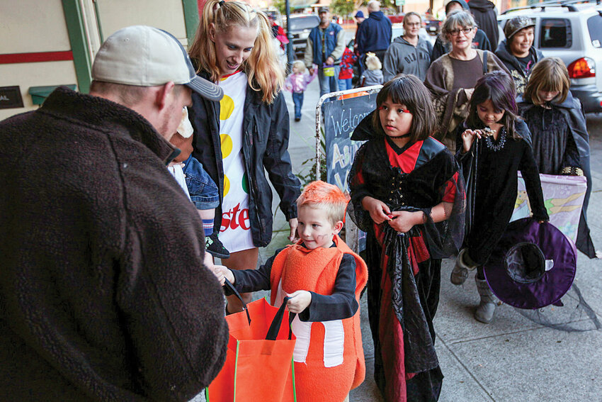 Children in costume walk along Main Street during a past Trick-or-Treat Trail. The 2025 trail begins 3 p.m., Oct. 31 at Battle Ground Plaza (Wilco) and continues east on Main Street to the Community Center.