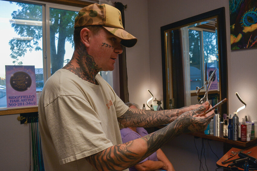 Justin Thomas shows the differences between several types of shears during a dry-cutting workshop at Ridgefield&rsquo;s Hair Artist on Sunday, Oct. 5. The Sacramento stylist and Hanzo educator visited Ridgefield to teach local artists advanced cutting techniques designed to preserve hair health.
