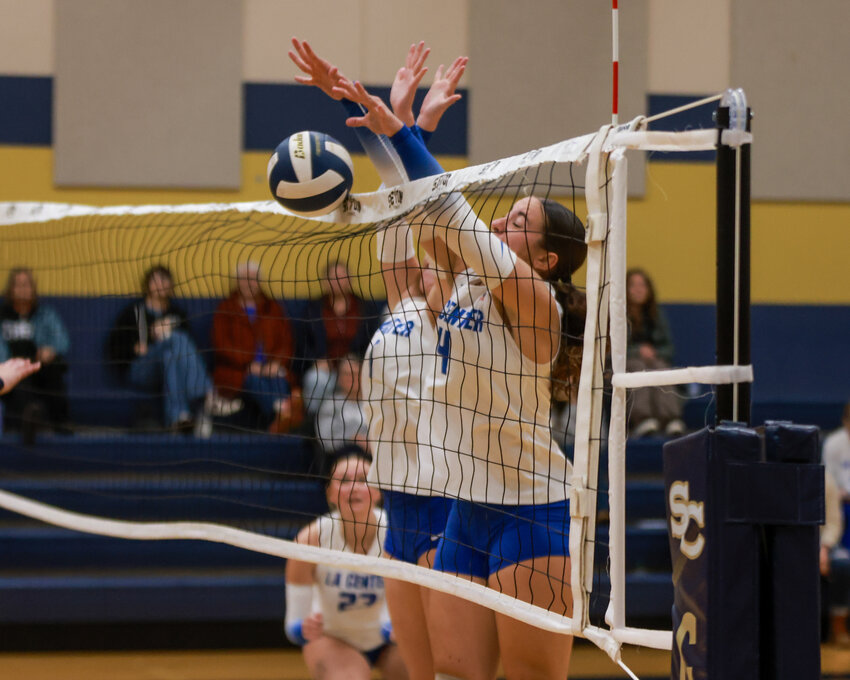 La Center&rsquo;s Bailey Espana, right, and Whitney Martell, form a wall to block a shot during the Wildcats&rsquo; three-set win over the Seton Catholic Cougars on Tuesday, Sept. 30.