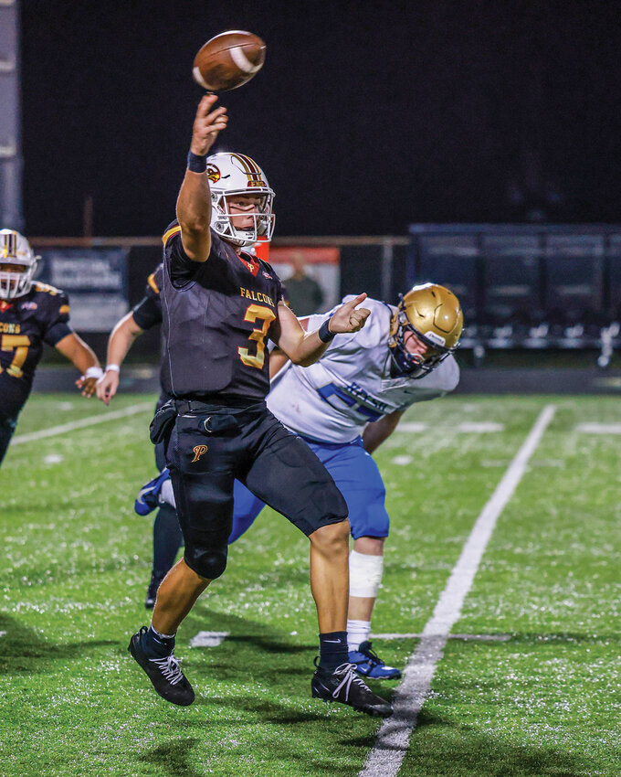 Prairie quarterback Deven Vigue slings the ball during the Falcons&rsquo; 20-14 loss to Kelso High School on Thursday, Oct. 9.