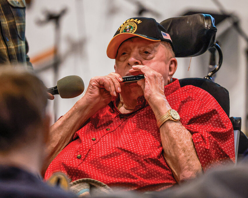 Milton Watson, of Woodland, plays the harmonica during his 100th birthday party on Saturday, Oct. 11.