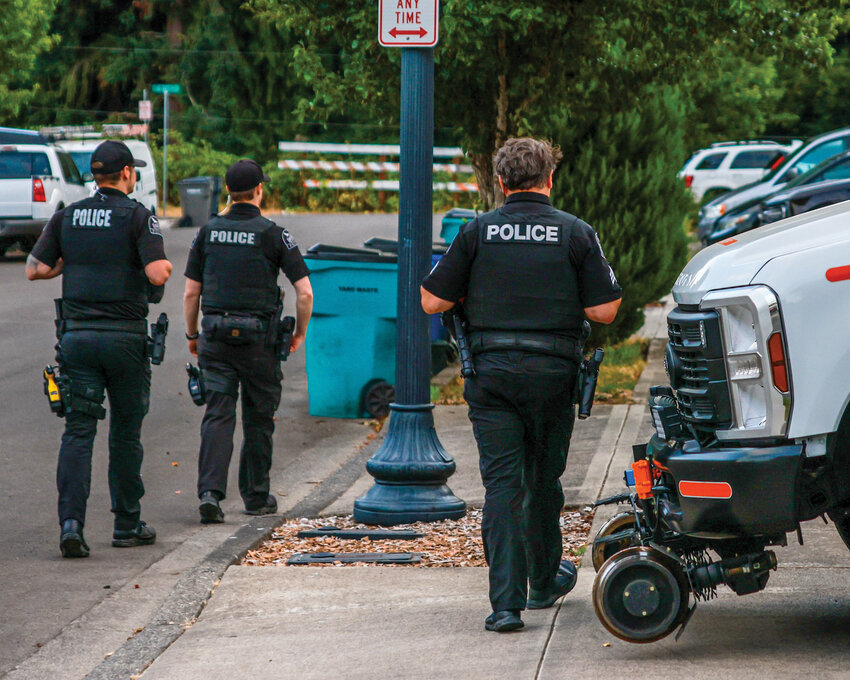 Ridgefield officers walk along a sidewalk while on patrol. The Ridgefield City Council voted unanimously Thursday, Oct. 9, to enact a 0.1% sales tax increase dedicated to public safety.