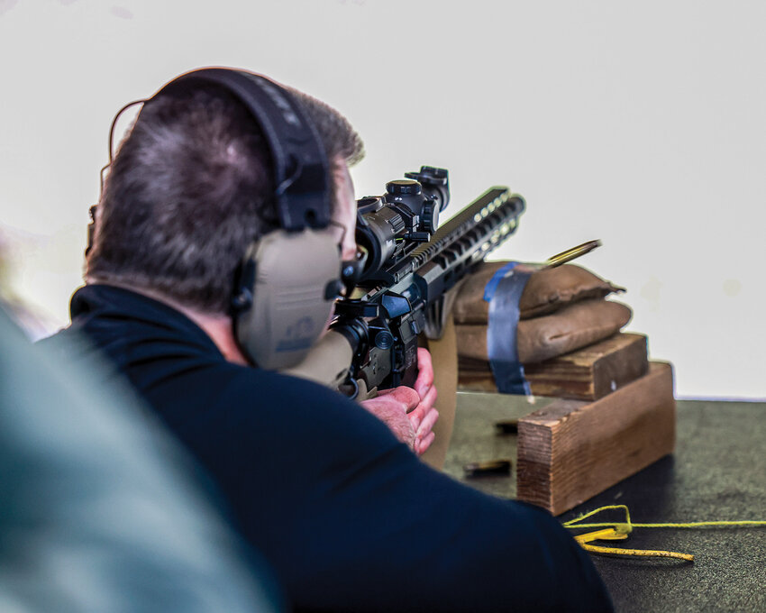 Battle Ground Police Chief Dennis Flynn tests his rifle skills during a shooting competition to build camaraderie between the Battle Ground Police Department and Clark County Fire District 3 at Clark Rifles on Wednesday, Oct. 8.