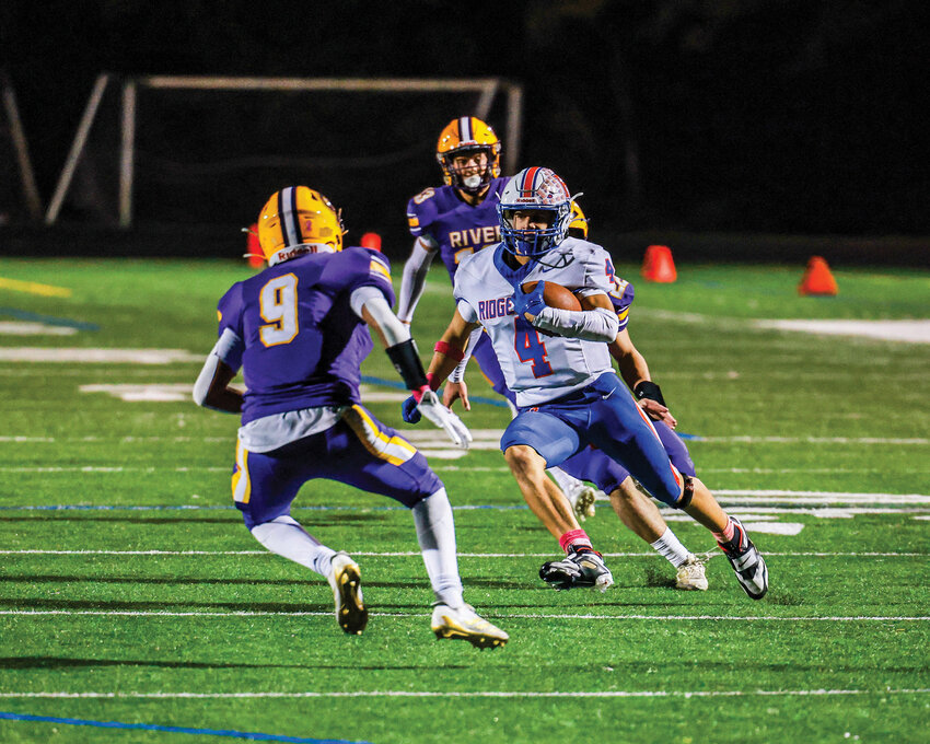 Ridgefield&rsquo;s Brian McLemore III cuts through the Columbia River Rapid punt defense on his way to the end zone for a punt return touchdown in the Spudders&rsquo; 19-14 loss on Friday, Oct. 17.
